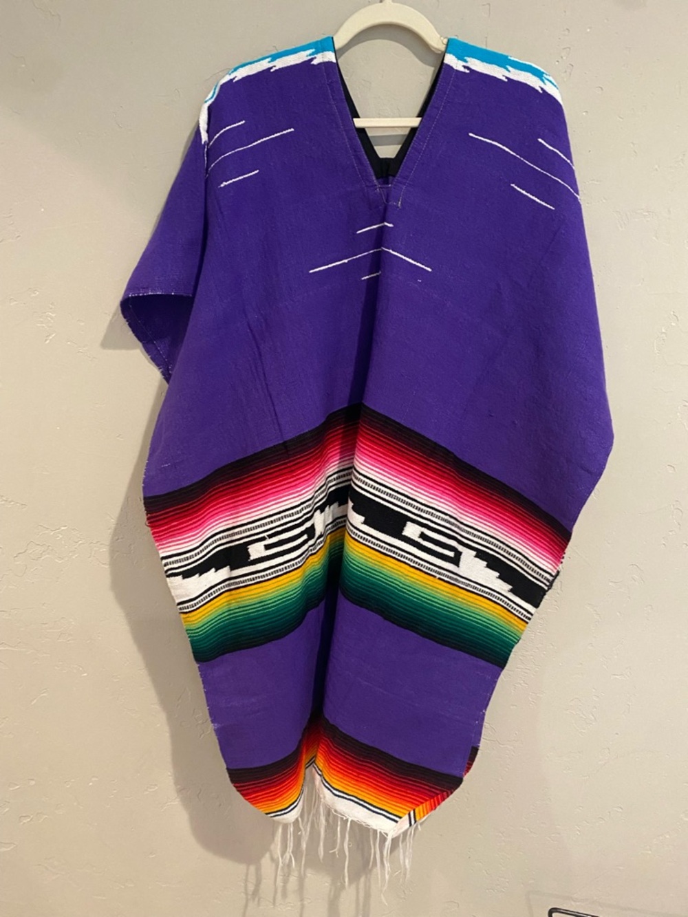 Purple Mexican Serape Poncho with Rainbow Stripes.
